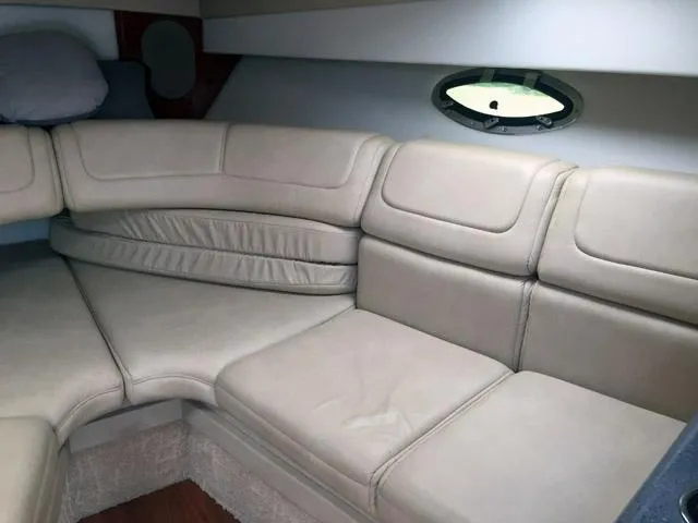 Slide: The Image of 2008 Formula 310 Sun Sport interior with beige leather seating and porthole window. - 4