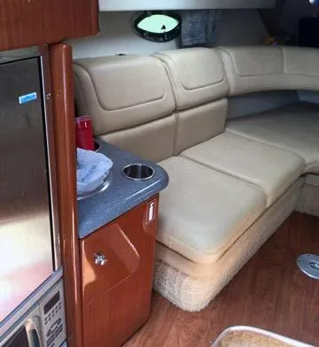 Slide: The Image of 2008 Formula 310 Sun Sport interior with beige seating and wooden cabinetry. - 6