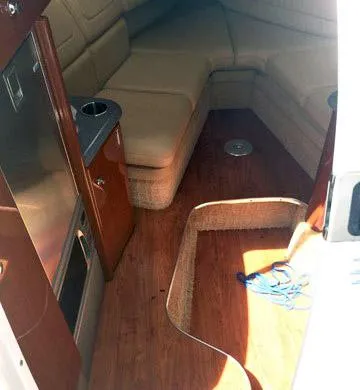 Slide: The Image of 2008 Formula 310 Sun Sport cabin interior with seating and wood flooring. - 7