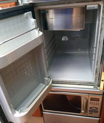 Slide: The Image of Empty refrigerator in a 2008 Formula 310 Sun Sport boat kitchen area. - 9
