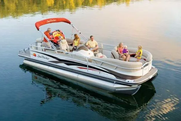 Slide: The Image of 2008 Sun Tracker Party Barge 25 I/O Regency Edition docked with red canopy. - 4