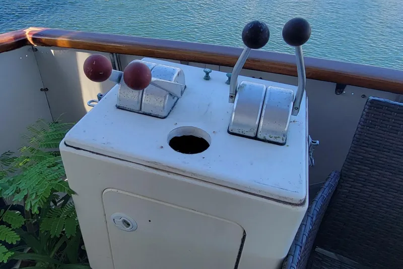 Slide: The Image of Control panel on 1982 Hatteras 56 Wide Body yacht, overlooking water. - 16