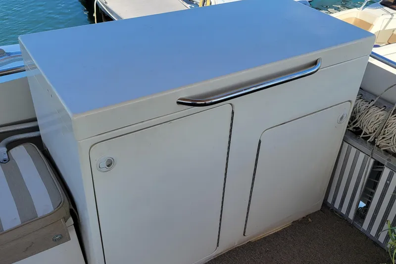 Slide: The Image of Cabinet on 1982 Hatteras 56 Wide Body yacht deck, featuring sleek design and chrome handle. - 24