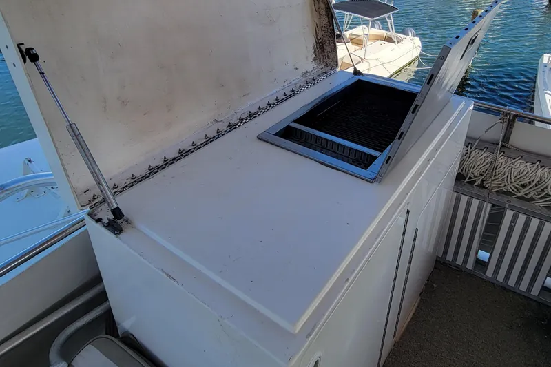 Slide: The Image of Outdoor grill on 1982 Hatteras 56 Wide Body yacht, docked by the water. - 25