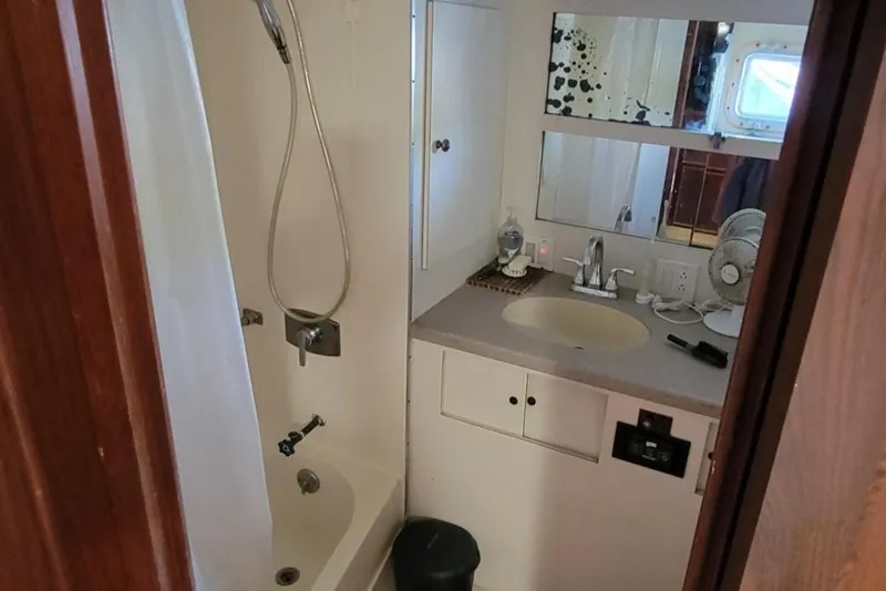 Slide: The Image of 1982 Hatteras 56 Wide Body yacht bathroom with shower, sink, and mirror. - 35
