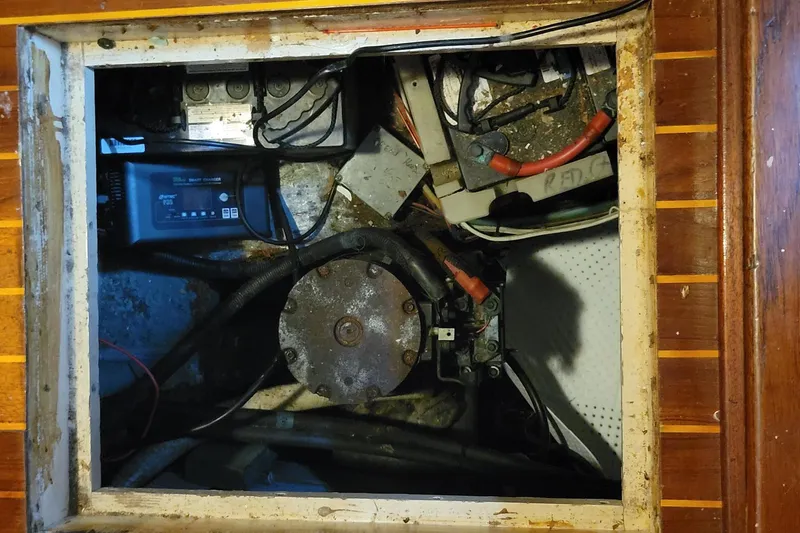 Slide: The Image of Engine compartment of 1982 Hatteras 56 Wide Body yacht, showing mechanical components and wiring. - 40