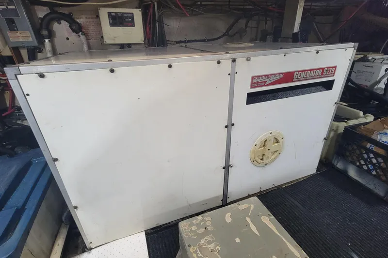 Slide: The Image of Engine room of 1982 Hatteras 56 Wide Body yacht with generator. - 48