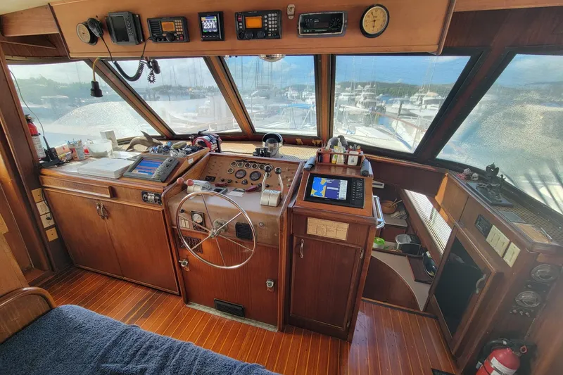 Slide: The Image of 1982 Hatteras 56 Wide Body yacht helm with wooden interior and navigation equipment. - 6
