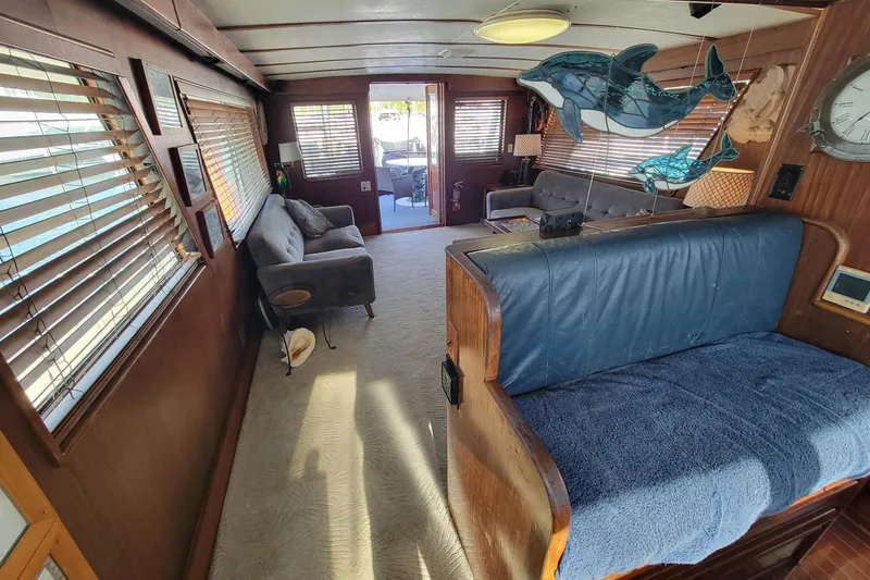 Slide: The Image of Interior of 1982 Hatteras 56 Wide Body yacht with cozy seating and nautical decor. - 9
