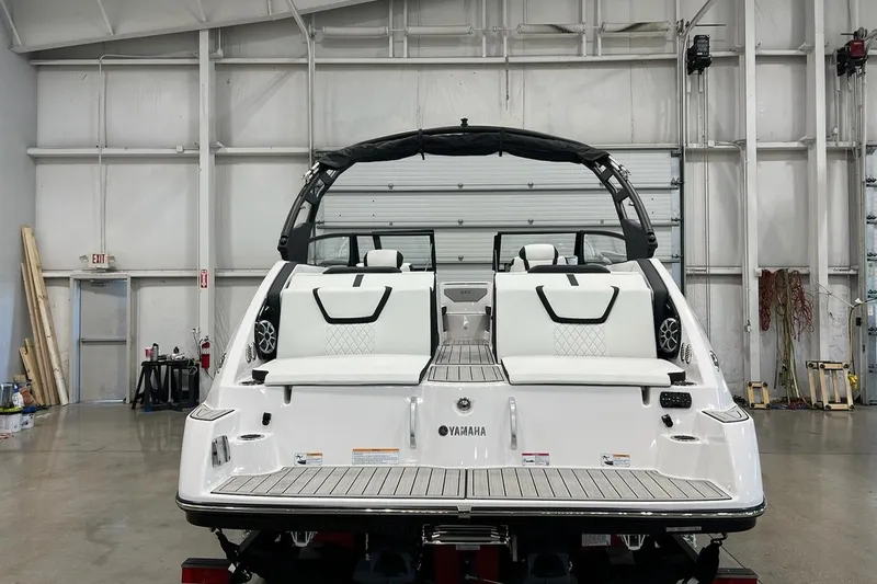 Slide: The Image of 2025 Yamaha Boats 222SE in a showroom, rear view showcasing sleek design. - 2