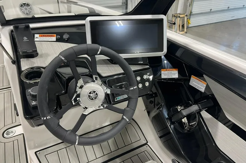 Slide: The Image of 2025 Yamaha Boats 222SE dashboard with steering wheel and touchscreen display. - 4