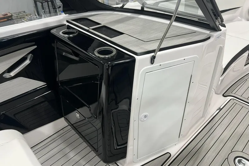 Slide: The Image of 2025 Yamaha Boats 222SE interior with sleek black and white design, featuring cup holders. - 7