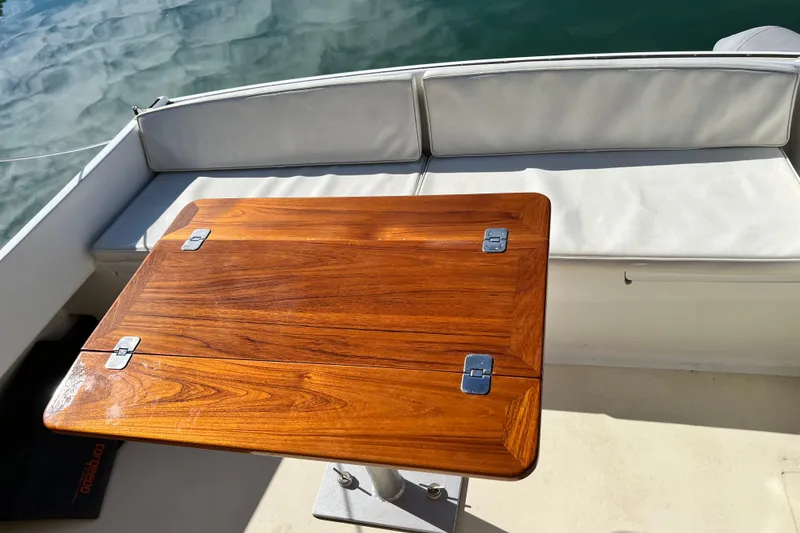 Slide: The Image of 1988 Jarvis Newman HARDTOP CRUISER with wooden table and white cushioned seating. - 14