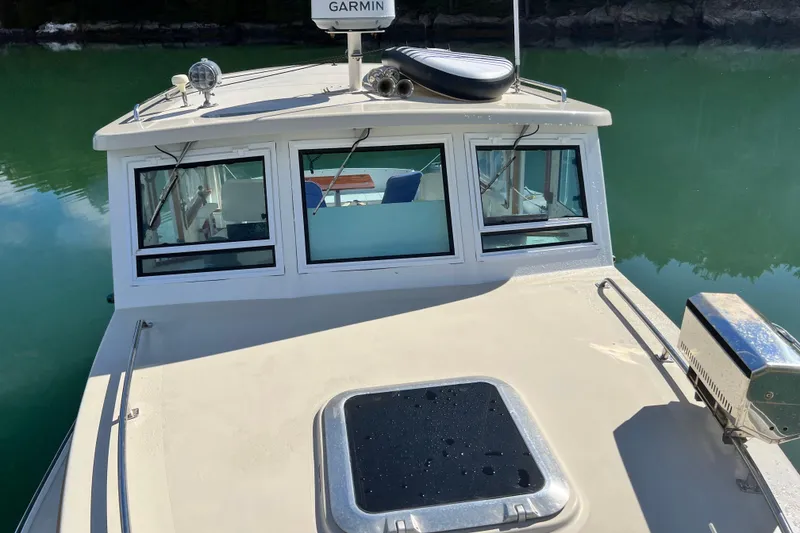 Slide: The Image of 1988 Jarvis Newman Hardtop Cruiser on calm water, featuring Garmin equipment. - 17