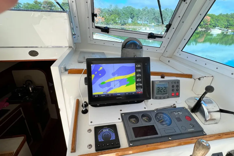 Slide: The Image of 1988 Jarvis Newman Hardtop Cruiser cockpit with navigation equipment and scenic view. - 4