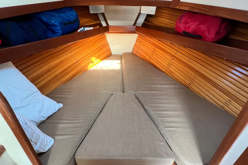 Slide: The Image of Cozy cabin interior of 1988 Jarvis Newman Hardtop Cruiser with wooden paneling and cushions. - 7