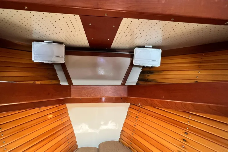 Slide: The Image of Interior of 1988 Jarvis Newman Hardtop Cruiser with wooden paneling and speakers. - 8