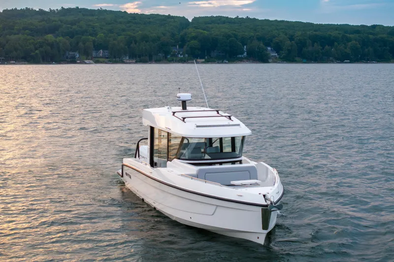 Slide: The Image of 2026 Cruisers Yachts 38 VTR cruising on a sunny day, reflecting on calm waters. - 14