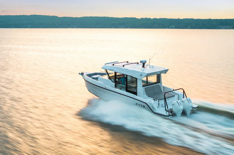 Slide: The Image of 2026 Cruisers Yachts 38 VTR on serene blue waters under a clear sky. - 15