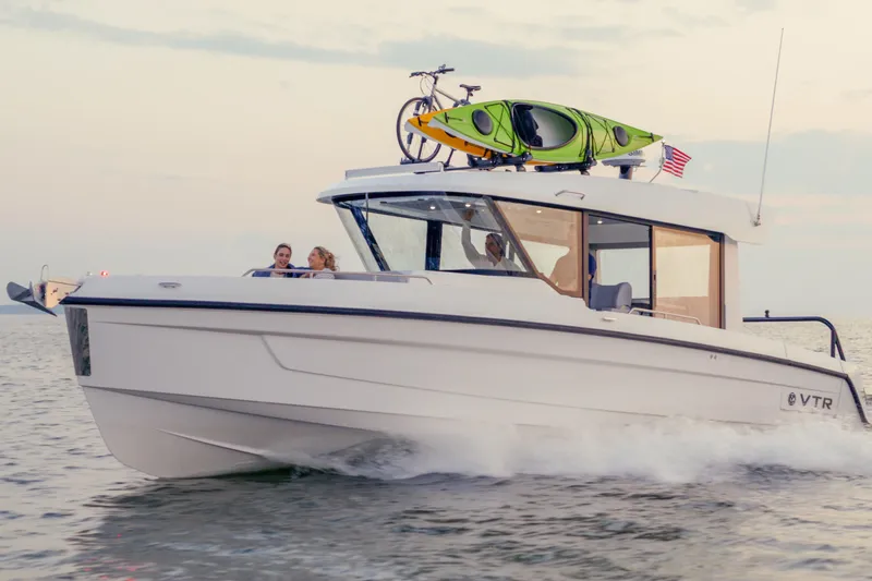 Slide: The Image of 2026 Cruisers Yachts 38 VTR on calm blue water, showcasing sleek design and spacious deck. - 17