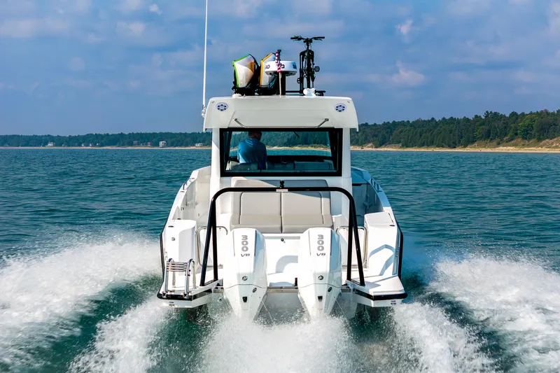 Slide: The Image of Interior view of 2026 Cruisers Yachts 38 VTR, featuring seating and table with scenic water view. - 6