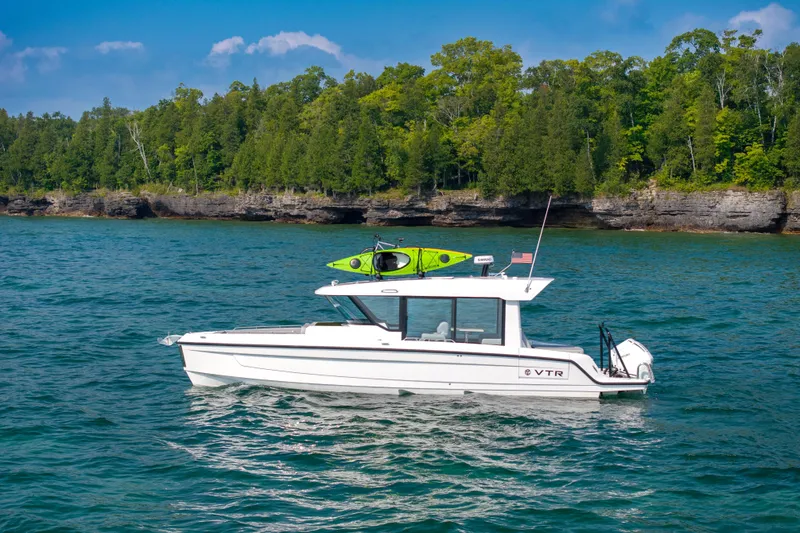 Slide: The Image of 2026 Cruisers Yachts 38 VTR helm with modern controls at a boat show. - 11