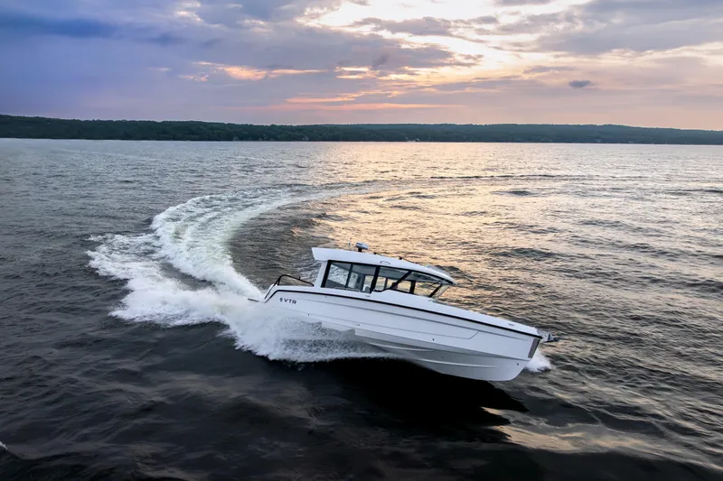 Slide: The Image of 2026 Cruisers Yachts 38 VTR at a boat show, side view with attendees. - 8