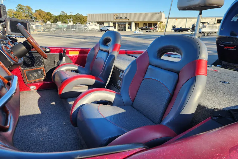 Slide: The Image of 2002 Triton Tr-20 ProDeck boat interior with red and gray seats, steering wheel, and controls. - 10