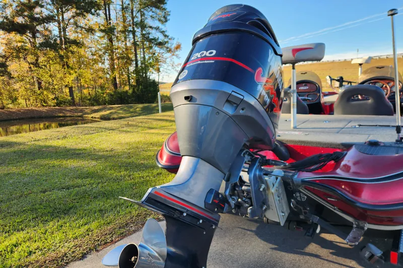 Slide: The Image of 2002 Triton Tr-20 ProDeck boat with powerful outboard motor in scenic outdoor setting. - 3