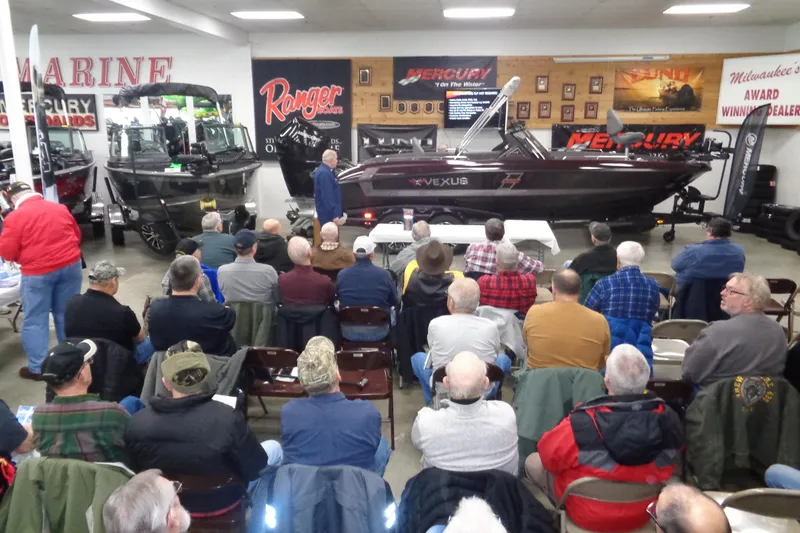 Slide: The Image of Audience attending a boat presentation featuring the 2025 Lund 1775 Adventure Sport. - 9