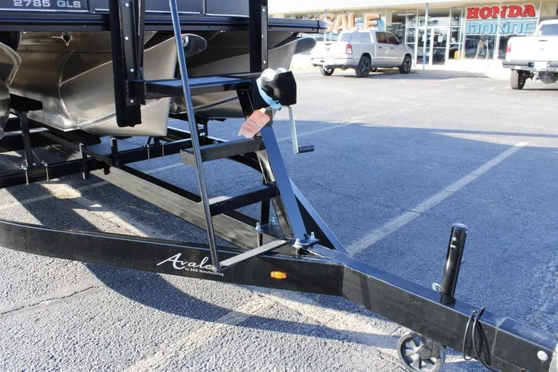 Slide: The Image of Trailer hitch of 2026 Avalon Catalina Quad Lounger 27 FT at dealership parking lot. - 10