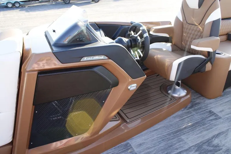 Slide: The Image of 2026 Avalon Catalina Quad Lounger 27 FT boat interior with steering wheel and captain's chair. - 26