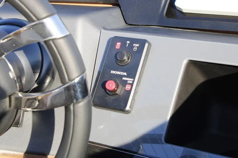 Slide: The Image of Steering wheel and control panel of 2026 Avalon Catalina Quad Lounger boat. - 30