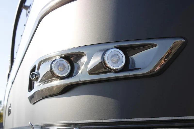 Slide: The Image of Close-up of 2026 Avalon Catalina Quad Lounger 27 FT boat's sleek chrome lighting detail. - 4