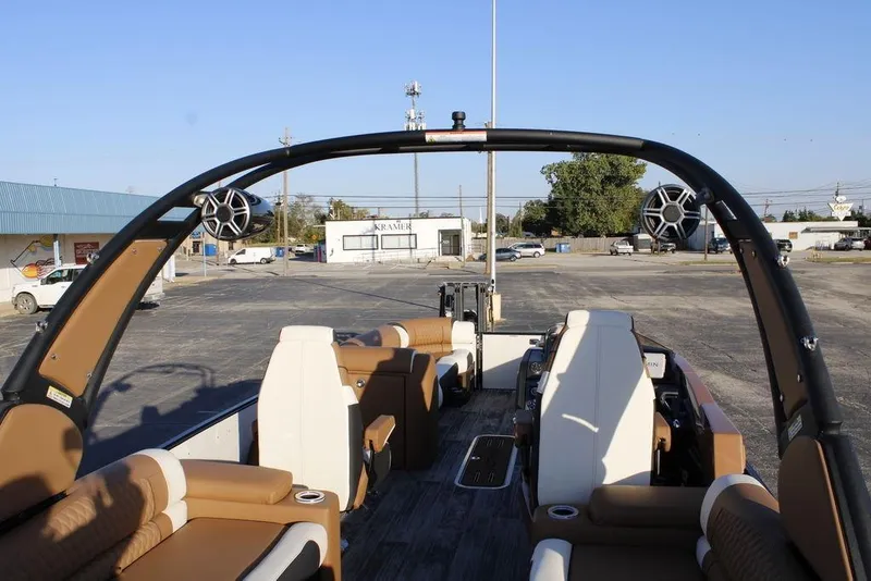 Slide: The Image of 2026 Avalon Catalina Quad Lounger 27 FT interior with seating and speakers in a parking lot. - 43