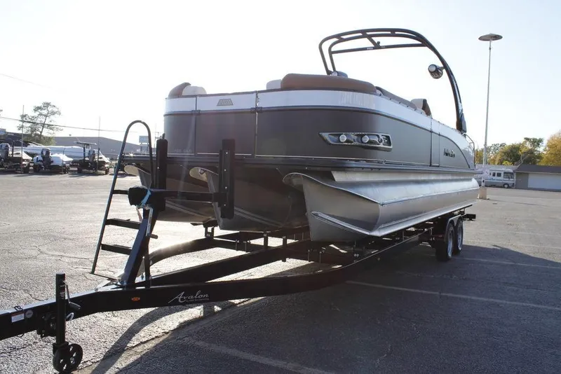 Slide: The Image of 2026 Avalon Catalina Quad Lounger 27 FT pontoon boat on trailer in parking lot. - 6