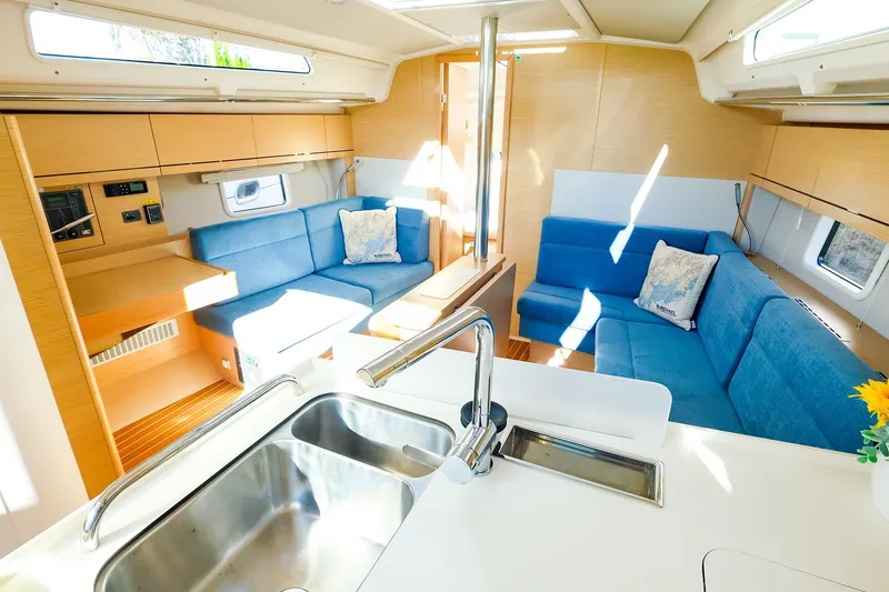 Slide: The Image of 2022 Hanse 388 yacht cockpit with wooden deck, dual helm, and seating area. - 2