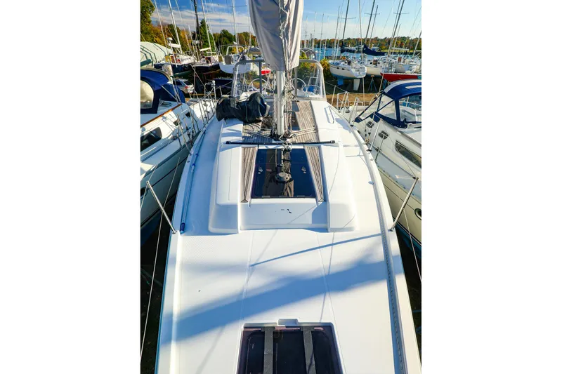 Slide: The Image of 2022 Hanse 388 sailboat deck view, docked among other boats. - 20
