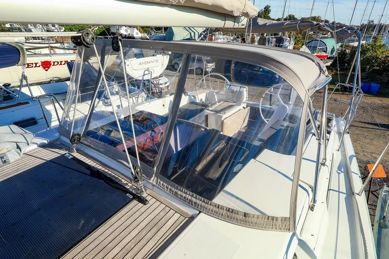 Slide: The Image of 2022 Hanse 388 sailboat with cockpit cover, docked in a marina. - 21