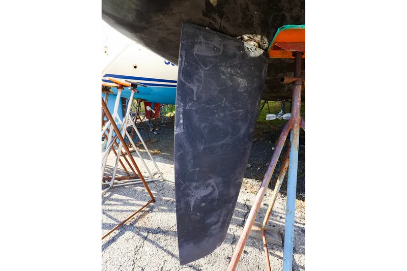 Slide: The Image of Hanse 388 sailboat keel, 2022 model, supported on stands in a boatyard. - 26