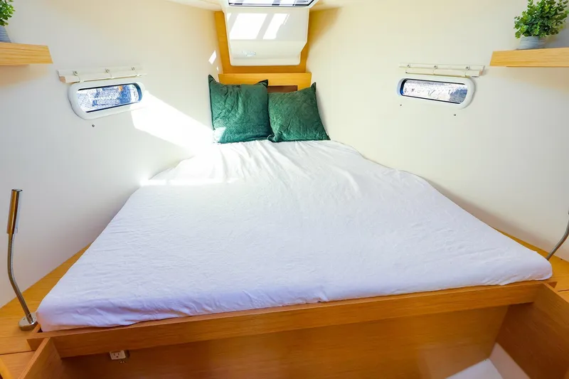 Slide: The Image of Interior of 2022 Hanse 388 yacht with blue sofa, navigation table, and nautical decor. - 7