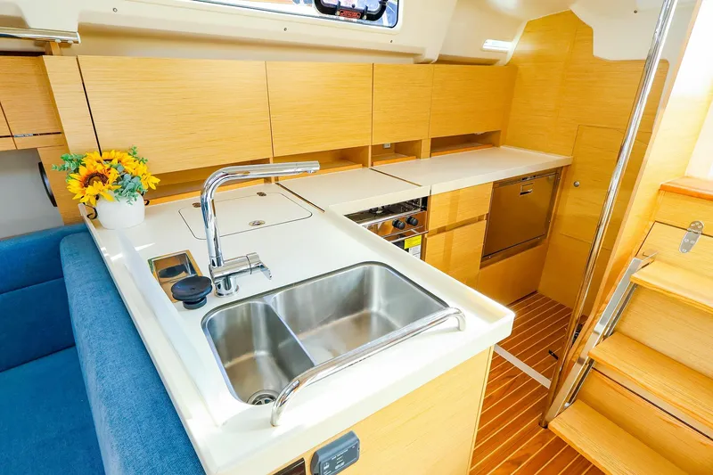 Slide: The Image of Cozy cabin interior of 2022 Hanse 388 yacht with double bed and porthole windows. - 8