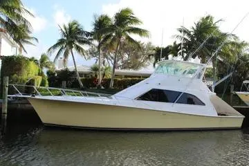 The Image of 1996 Ocean 53 Super Sport yacht docked by palm trees. - 1