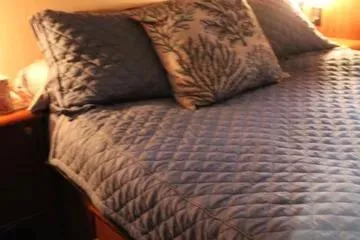 Slide: The Image of Quilted bed with decorative pillows in 1996 Ocean 53 Super Sport yacht cabin. - 10