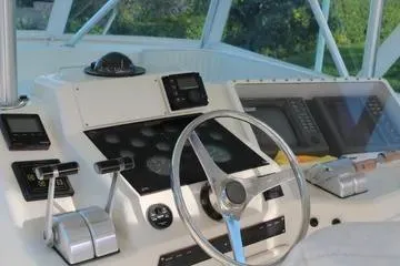 Slide: The Image of 1996 Ocean 53 Super Sport yacht helm with steering wheel and navigation controls. - 12
