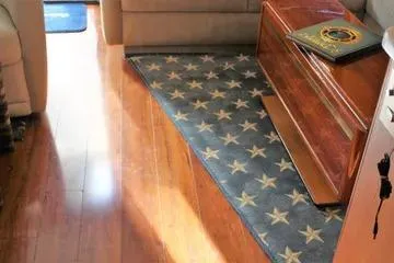 Slide: The Image of Interior of 1996 Ocean 53 Super Sport yacht with star-patterned rug and wooden flooring. - 4