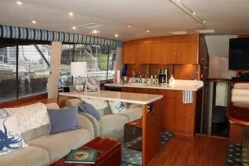 Slide: The Image of Interior of 1996 Ocean 53 Super Sport yacht with modern furnishings and kitchen area. - 5