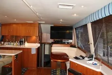 Slide: The Image of Interior of a 1996 Ocean 53 Super Sport yacht with modern amenities and wood finishes. - 6