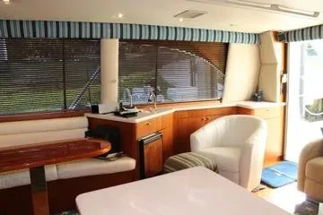 Slide: The Image of Interior of a 1996 Ocean 53 Super Sport yacht with elegant seating and wood finishes. - 7