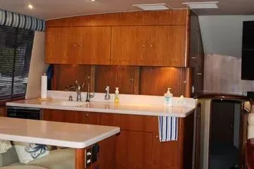 Slide: The Image of Interior of 1996 Ocean 53 Super Sport yacht with wooden cabinetry and modern kitchen amenities. - 8